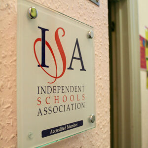 This is a photograph of the independent schools association accredited member plaque.